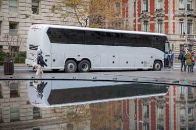 Bus reflected in fountain