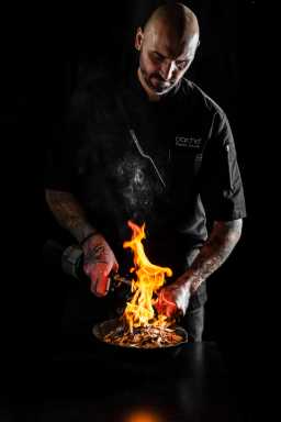 Bartender working with flames to make unique cocktail